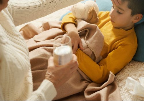 Woman caring of her child and giving him water